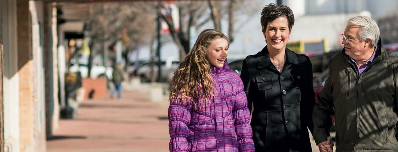 Young and older generations talking on a street, representing support for lower back pain relief.