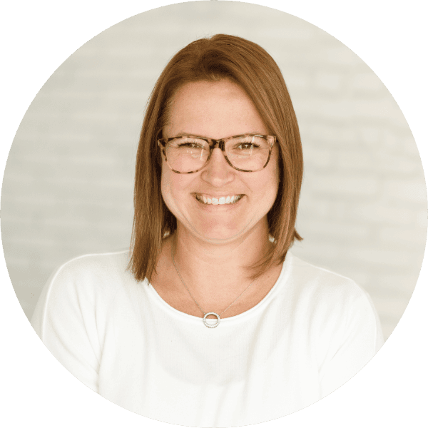 A General Practitioner (GP) smiling at the camera.