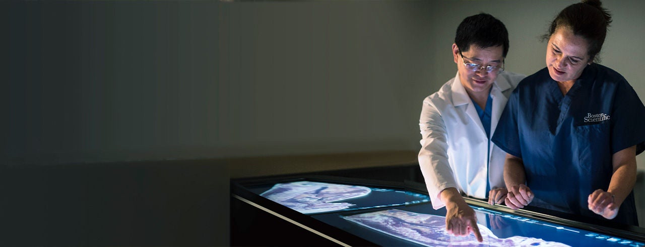 Pain specialist and Boston Scientific representative discussing treatment options in a clinical setting.