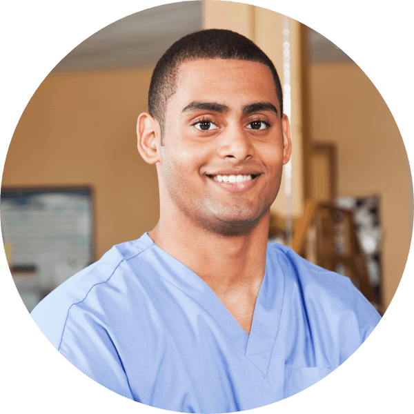 A physiotherapist or occupational therapist smiling at the camera.