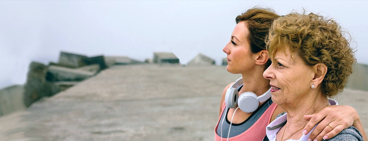 Mother and daughter peacefully enjoying an outdoor view together.