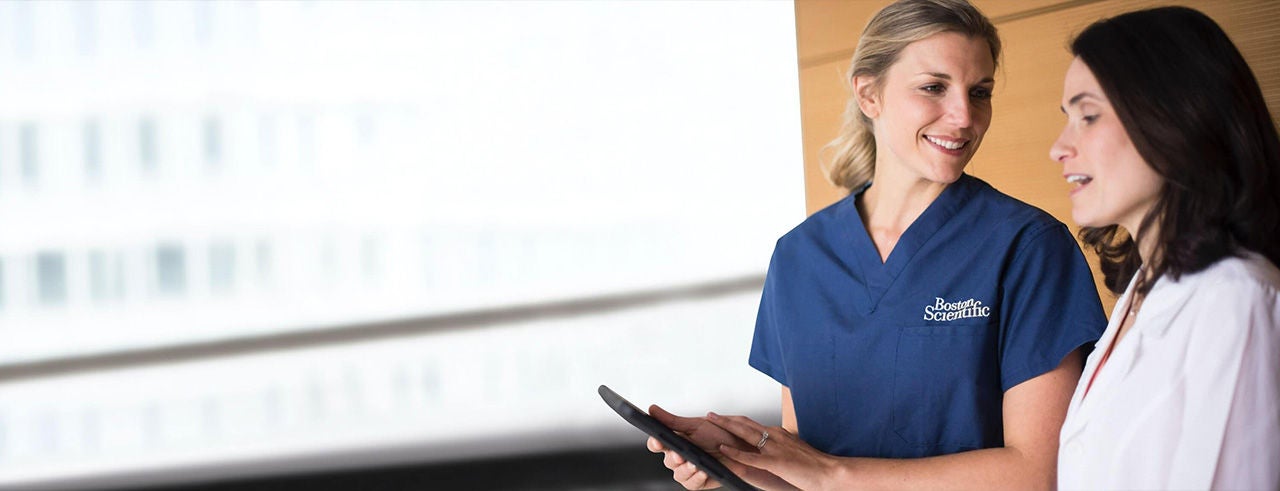 Pain specialist and Boston Scientific representative discussing treatment options in a clinical setting.