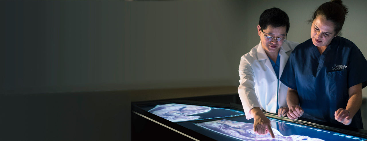 Doctors discuss and pointing on screen.