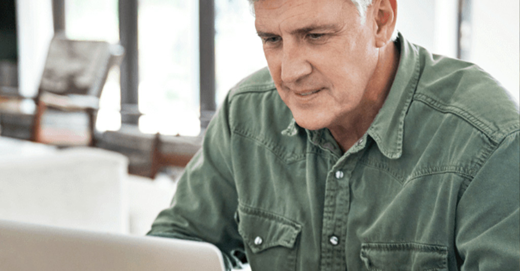 A man working on a laptop.