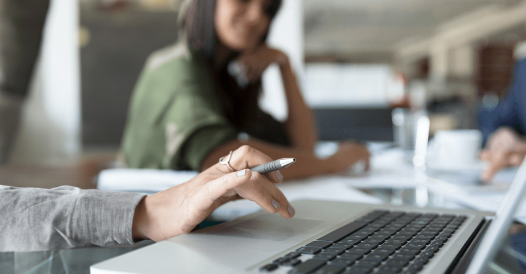 A woman working on a laptop.