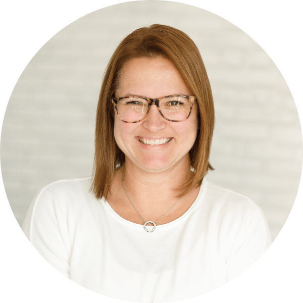 A General Practitioner (GP) smiling at the camera.